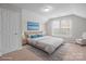 Staged bedroom with sloped ceilings features a cozy bed and lots of natural light from the double windows at 9413 Pastern Ct, Charlotte, NC 28216