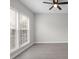 Bright and airy bedroom with a ceiling fan, natural light, and hardwood floors at 9413 Pastern Ct, Charlotte, NC 28216