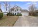 Well-maintained two-story home with blue shutters and an attached two-car garage, perfect for Gathering living at 9413 Pastern Ct, Charlotte, NC 28216