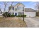 Charming two-story home featuring blue shutters, a well-manicured lawn, and a two-car garage at 9413 Pastern Ct, Charlotte, NC 28216