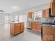 Open kitchen with island and modern appliances adjoins living area with fireplace at 9413 Pastern Ct, Charlotte, NC 28216