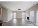 Bright living room boasts neutral walls, windows, a ceiling fan, and a cozy fireplace at 9413 Pastern Ct, Charlotte, NC 28216