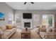 Comfortable living room with fireplace, furnishings, and a view to the outside at 9413 Pastern Ct, Charlotte, NC 28216