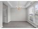 Inviting living room featuring a tray ceiling, modern chandelier, hardwood floors and natural lighting at 9413 Pastern Ct, Charlotte, NC 28216