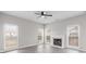 Spacious living room with a decorative fireplace, hardwood floors, and plenty of natural light at 9413 Pastern Ct, Charlotte, NC 28216