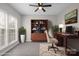 Cozy home office setup with stylish shelving, a comfortable desk, and large windows for ample light at 9413 Pastern Ct, Charlotte, NC 28216
