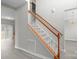 Inviting staircase features carpeted steps and a wooden banister at 9413 Pastern Ct, Charlotte, NC 28216