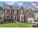 Beautiful brick home featuring a well-manicured lawn, two car garage, and black shutters at 9711 Tenencia Ct, Charlotte, NC 28277