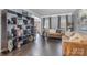 Living room with wood floors, a decorative bookcase, and neutral paint at 9711 Tenencia Ct, Charlotte, NC 28277