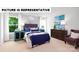 Well-decorated bedroom with a queen bed, stylish nightstands, and bright natural light at 104 Woodhall Way, Troutman, NC 28166
