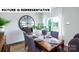 Beautiful dining room with an accent clock, a wooden table, comfortable chairs, and bright natural light at 104 Woodhall Way, Troutman, NC 28166