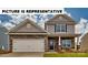 Charming two-story home featuring stone accents, a two-car garage, and a welcoming front porch. The property boasts curb appeal at 104 Woodhall Way, Troutman, NC 28166