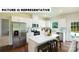 Modern kitchen with stainless steel appliances, white cabinets, island with seating, and adjacent to the backyard patio at 104 Woodhall Way, Troutman, NC 28166