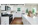 Stylish kitchen with stainless steel appliances, white cabinets, and a center island at 104 Woodhall Way, Troutman, NC 28166