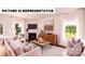 Inviting living room with a fireplace, comfortable seating, hardwood floors, and plenty of natural light at 104 Woodhall Way, Troutman, NC 28166