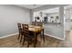 Dining area with a wooden table, seating for four, and an open view into the kitchen at 11420 Glaetzer Ln, Charlotte, NC 28270