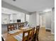 Dining area leading to a kitchen with white cabinets, and providing access to a half bath at 11420 Glaetzer Ln, Charlotte, NC 28270
