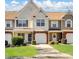 Charming townhome featuring a well-manicured lawn, attached garages, and a welcoming facade at 11420 Glaetzer Ln, Charlotte, NC 28270
