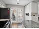 Bright kitchen featuring stainless steel appliances and granite island with direct access to the patio at 11420 Glaetzer Ln, Charlotte, NC 28270