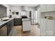 Modern kitchen with stainless steel appliances, white cabinets, and an island at 11420 Glaetzer Ln, Charlotte, NC 28270