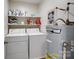 Efficient laundry room with washer, dryer, storage shelves, and water heater at 11420 Glaetzer Ln, Charlotte, NC 28270