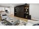 Living room featuring a decorative bookshelf, hardwood floors, and an elegant coffee table at 11420 Glaetzer Ln, Charlotte, NC 28270