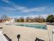Well-maintained community pool surrounded by mature trees and neighboring houses at 11420 Glaetzer Ln, Charlotte, NC 28270