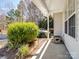 Inviting porch with green foliage enhancing the property's curb appeal at 11420 Glaetzer Ln, Charlotte, NC 28270