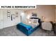 Charming bedroom with a comfortable bed, desk, and artistic wall decorations at 122 Woodhall Way, Troutman, NC 28166