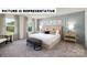 Elegant bedroom featuring large windows, a bed with decorative pillows, and accent wall paneling at 122 Woodhall Way, Troutman, NC 28166