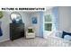Charming Bedroom with a crib, dresser, accent chair, and soft blue color scheme at 122 Woodhall Way, Troutman, NC 28166