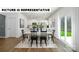 Bright dining area features wood floors, a long table and chairs, and sliding glass doors to backyard at 122 Woodhall Way, Troutman, NC 28166