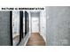 Inviting hallway with hardwood floors, stylish mirrors and textured wallpaper leading to various rooms at 122 Woodhall Way, Troutman, NC 28166