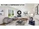 Bright living room features modern furnishings, a decorative fireplace, and a large window with natural light at 122 Woodhall Way, Troutman, NC 28166