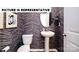 Chic powder room featuring an oval mirror, pedestal sink, and stylish herringbone wallpaper at 122 Woodhall Way, Troutman, NC 28166