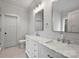 Elegant bathroom with double sinks, marble countertop, and ample cabinet space at 12243 Monteith Grove Dr, Huntersville, NC 28078