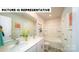 Bathroom with dual sinks, white cabinets, and tub with shower at 126 Woodhall Way, Troutman, NC 28166