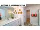 Stylish bathroom features double sinks, decorative accents, and a separate toilet room at 126 Woodhall Way, Troutman, NC 28166