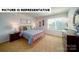 This is a staged bedroom featuring an orange bed frame and a dresser with a mirror at 126 Woodhall Way, Troutman, NC 28166