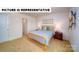 This is a staged bedroom featuring an orange bed frame, tan carpet, and 2 skateboards mounted on the wall at 126 Woodhall Way, Troutman, NC 28166