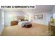 Spacious main bedroom features neutral carpet, vaulted ceiling, and side tables at 126 Woodhall Way, Troutman, NC 28166