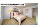This is a staged bedroom featuring a queen bed, 2 windows, tan carpet, and decorative art at 126 Woodhall Way, Troutman, NC 28166