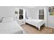 Bright bedroom features two twin beds, wood floors, and sun-filled windows at 1304 Browdis Ave, Kannapolis, NC 28083