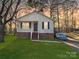Cozy home featuring a brick foundation, lush green lawn, and a covered car for protection at 1304 Browdis Ave, Kannapolis, NC 28083