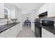 Charming kitchen with black appliances, white cabinets, and tile backsplash at 1304 Browdis Ave, Kannapolis, NC 28083