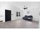 Bright living room with vaulted ceilings, tile floors, and black entrance door at 1304 Browdis Ave, Kannapolis, NC 28083