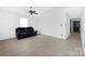 Open living room featuring tile floors, ceiling fan and a comfortable sofa at 1304 Browdis Ave, Kannapolis, NC 28083