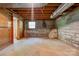 Spacious unfinished basement has concrete floor and small window at 1330 College Ave, Shelby, NC 28152