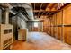 Exposed basement featuring utilities, laundry hookups, and an exterior door at 1330 College Ave, Shelby, NC 28152