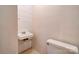 Small half bathroom with a toilet and wall-mounted sink at 1330 College Ave, Shelby, NC 28152